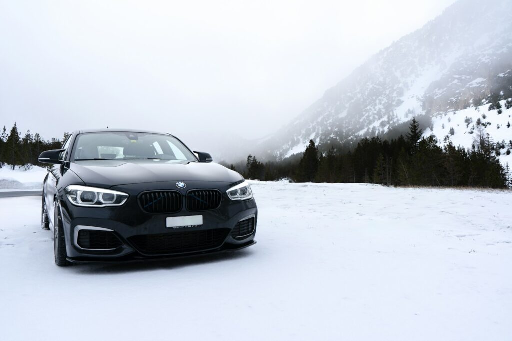 A black car parked on a snowy road